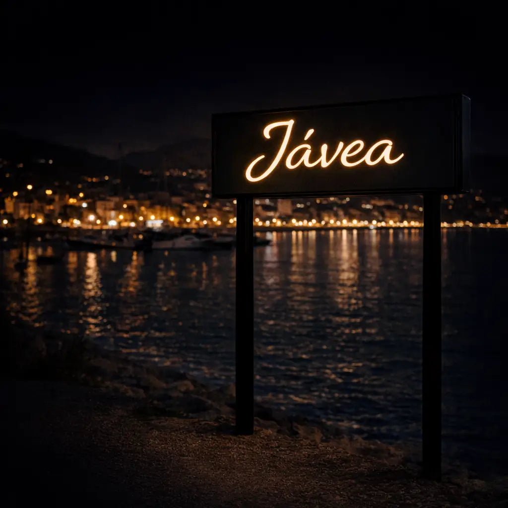 Jávea illuminated city sign at night representing car rental location